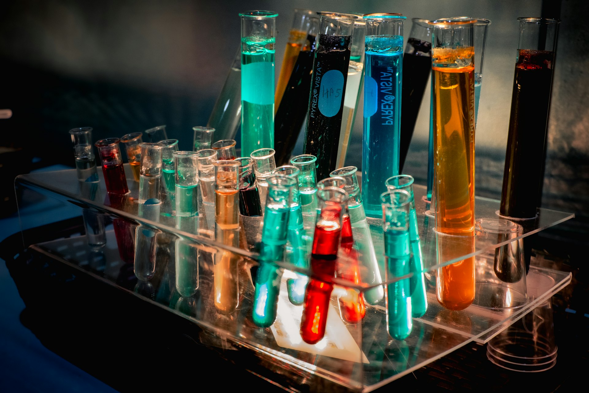 a bunch of test tubes filled with different colored liquids